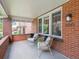 Inviting front porch featuring brick accents, stylish seating, and a glimpse of the neighborhood at 660 S Clarkson St, Denver, CO 80209