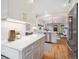Kitchen features stainless appliances, white cabinets, and a breakfast bar open to the living room at 660 S Clarkson St, Denver, CO 80209