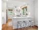 Bright kitchen with stainless steel appliances, white cabinets, and a breakfast bar with seating at 660 S Clarkson St, Denver, CO 80209