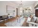 Cozy living room with hardwood floors, neutral decor, and an open layout to the kitchen at 660 S Clarkson St, Denver, CO 80209