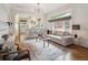 Open-concept living area with hardwood floors, neutral decor, and seamless flow to the kitchen at 660 S Clarkson St, Denver, CO 80209