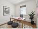 Office features white walls, hardwood floors, one window, and modern desk setup at 660 S Clarkson St, Denver, CO 80209