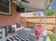 Covered patio area with modern furniture, outdoor lighting, and a mounted TV at 660 S Clarkson St, Denver, CO 80209