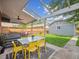 A covered patio includes a ceiling fan, a table with chairs, and backyard access at 660 S Clarkson St, Denver, CO 80209