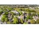 Scenic aerial view of the multi-unit building, surrounded by lush landscaping and trees at 16001 E Alaska Pl # 12, Aurora, CO 80017