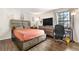 Relaxing bedroom features a large window with natural light, complemented by stylish furniture and a functional workspace at 16001 E Alaska Pl # 12, Aurora, CO 80017