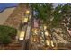 Charming condo exterior with stone accents, complemented by lush greenery and a welcoming entrance. Evening view at 16001 E Alaska Pl # 12, Aurora, CO 80017