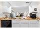 Bright kitchen featuring white cabinets and wood countertops, seamlessly connecting to the cozy living room with a fireplace at 16001 E Alaska Pl # 12, Aurora, CO 80017