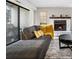 Cozy living room with a fireplace, sliding door access to the outside, and a comfortable couch with decorative pillows at 16001 E Alaska Pl # 12, Aurora, CO 80017