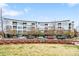 Apartment building with modern architecture, large windows, and lush landscaping at 2958 Syracuse St # 412, Denver, CO 80238