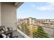 Balcony with outdoor chairs overlooking building exteriors and landscape at 2958 Syracuse St # 412, Denver, CO 80238