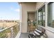 Balcony with seating area that provides lots of light into the interior through open glass doors at 2958 Syracuse St # 412, Denver, CO 80238