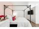 Bedroom features a unique canopy bed, adjacent to a flat screen TV, and modern decor at 2958 Syracuse St # 412, Denver, CO 80238