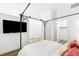 A bedroom with a door leading to a closet. Adjacent is a flat screen television at 2958 Syracuse St # 412, Denver, CO 80238