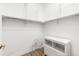 Walk-in closet with installed shelving, and a small seating area next to storage drawers at 2958 Syracuse St # 412, Denver, CO 80238