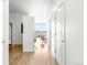 Bright hallway with wood floors leading to a window with natural light and a small office space at 2958 Syracuse St # 412, Denver, CO 80238