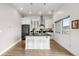 Modern kitchen features white cabinets, a black island, and stainless steel appliances at 2958 Syracuse St # 412, Denver, CO 80238