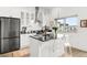 Modern kitchen with a large island, black appliances, and stylish white cabinets at 2958 Syracuse St # 412, Denver, CO 80238
