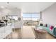 Open floor plan with a living room area bathed in natural light from expansive windows at 2958 Syracuse St # 412, Denver, CO 80238
