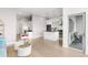 Bright, open living space with a kitchen island, desk, and access to an outdoor patio at 2958 Syracuse St # 412, Denver, CO 80238