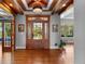 Grand entrance featuring a wood door, hardwood floors, and ample natural light, offering a warm welcome at 422 Suffolk Ln, Castle Rock, CO 80108