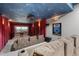 Home theater with tiered seating, projector screen, ceiling stars, and movie poster decor at 422 Suffolk Ln, Castle Rock, CO 80108