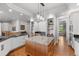 Spacious kitchen with an island, stainless steel appliances, hardwood floors, and custom cabinetry at 422 Suffolk Ln, Castle Rock, CO 80108