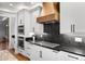 Modern kitchen featuring white cabinets, stainless steel appliances, and sleek countertops for a stylish cooking space at 422 Suffolk Ln, Castle Rock, CO 80108