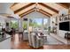 Cozy living room featuring a stone fireplace, wood floors, and large windows for lots of natural light at 422 Suffolk Ln, Castle Rock, CO 80108