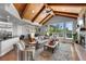 Open concept living room with vaulted ceilings, exposed beams, and expansive windows showcasing outdoor views at 422 Suffolk Ln, Castle Rock, CO 80108