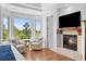 Serene main bedroom featuring a fireplace, sitting area, and bay windows offering beautiful green views at 422 Suffolk Ln, Castle Rock, CO 80108