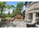 Outdoor stone fireplace with seating area, enhancing the backyard's ambiance and creating a cozy gathering spot at 422 Suffolk Ln, Castle Rock, CO 80108