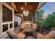 Outdoor living space with a fireplace, comfortable seating, and a built-in grill, ideal for entertaining at 422 Suffolk Ln, Castle Rock, CO 80108