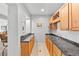 Functional wet bar area with wooden cabinetry, tiled countertops, sink, and built-in microwave at 422 Suffolk Ln, Castle Rock, CO 80108