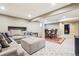 Finished basement featuring large sectional, dining table and neutral carpet at 7925 W Layton Ave # 500, Littleton, CO 80123