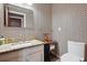 Half bathroom with patterned wallpaper, granite countertop, and modern fixtures at 7925 W Layton Ave # 500, Littleton, CO 80123