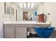 Bright bathroom features a large mirror, vanity, and wood floors at 7925 W Layton Ave # 500, Littleton, CO 80123
