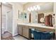 Bright bathroom features a large mirror, walk-in shower, vanity, and wood floors at 7925 W Layton Ave # 500, Littleton, CO 80123