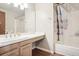 Bright bathroom features a large mirror, shower-tub combination, and clean white countertops at 7925 W Layton Ave # 500, Littleton, CO 80123