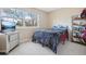Cozy bedroom with a large window, neutral carpet, and ample natural light at 7925 W Layton Ave # 500, Littleton, CO 80123
