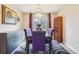 Elegant dining room with stylish purple chairs and crystal chandelier at 7925 W Layton Ave # 500, Littleton, CO 80123