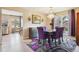 Elegant dining room with stylish purple chairs, modern decor, and natural light at 7925 W Layton Ave # 500, Littleton, CO 80123