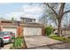 Charming brick home featuring an attached garage and a well-maintained front yard with mature trees at 7925 W Layton Ave # 500, Littleton, CO 80123