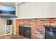 Living area featuring fireplace with brick surround, mantle, and media center at 7925 W Layton Ave # 500, Littleton, CO 80123