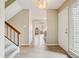 Entryway featuring light colored floors, leading to staircase, kitchen, and living space at 7925 W Layton Ave # 500, Littleton, CO 80123