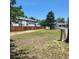 Expansive backyard featuring a wooden fence, mature trees, and ample space for outdoor activities and entertaining at 256 S 2Nd Ave, Brighton, CO 80601