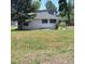 A single-story home features white siding and a well-maintained lawn at 256 S 2Nd Ave, Brighton, CO 80601