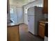 Functional kitchen with appliances and white walls creating a bright space at 256 S 2Nd Ave, Brighton, CO 80601