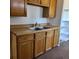 Classic kitchen featuring light wood cabinets and a stainless steel double sink at 256 S 2Nd Ave, Brighton, CO 80601