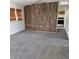 Inviting living room featuring plush carpeting and an accent wall at 256 S 2Nd Ave, Brighton, CO 80601